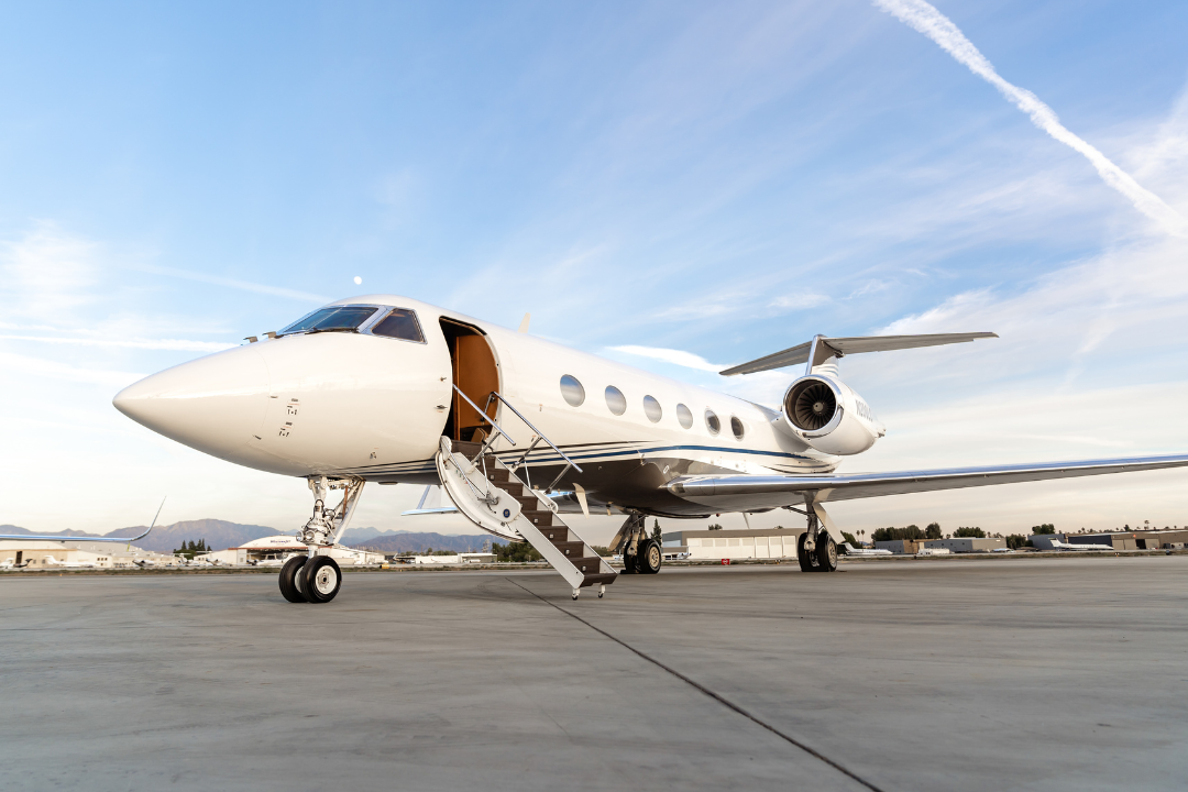 Private executive charter plane in flight above clouds